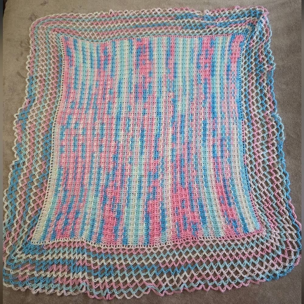 Vintage Handmade Crochet Blanket Featuring pastel pink, blue, and white colours
